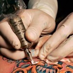 Tattoo artist working