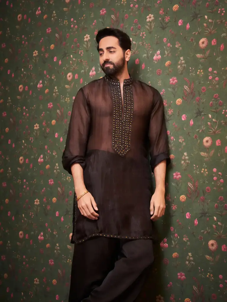Ayushmann Khurrana standing beside Tahira Kashyap in a black kurta ensemble