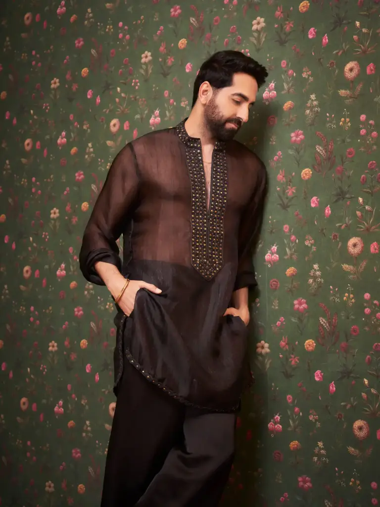Ayushmann Khurrana in a sheer black kurta with an embroidered front placket and subtle gold accents