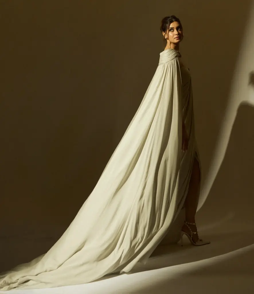 Diana Penty’s pleated gown with a flowing skirt and semi-sheer cape extending into a train