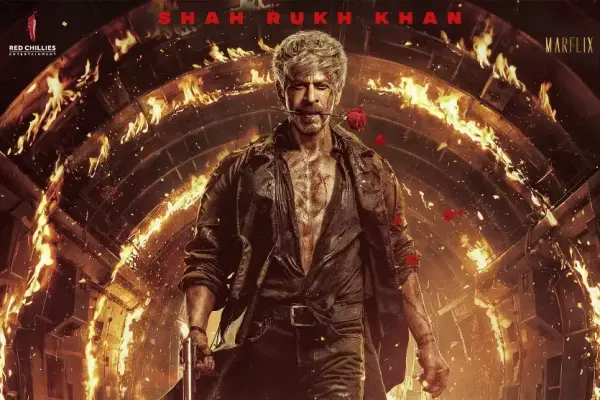 Shah Rukh Khan holds a red rose between his lips against blazing flames in the new King poster.
