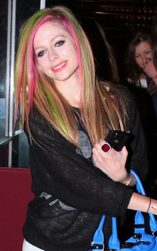 Avril Lavigne sports pink green streaked hair