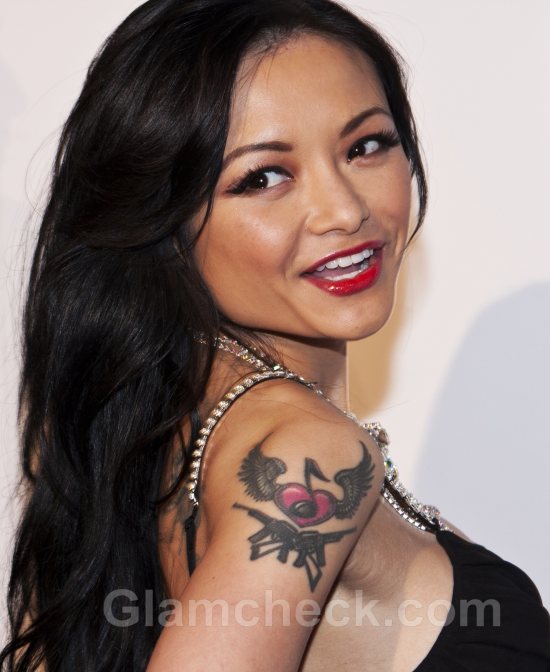Winged Heart and Guns on right upper arm: Tila Tequila Tattoo.