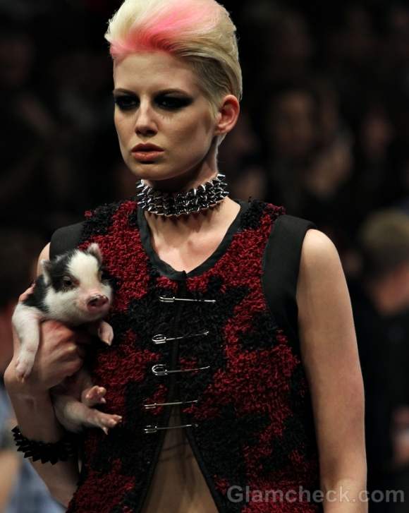 Models walk the ramp with cute piglets