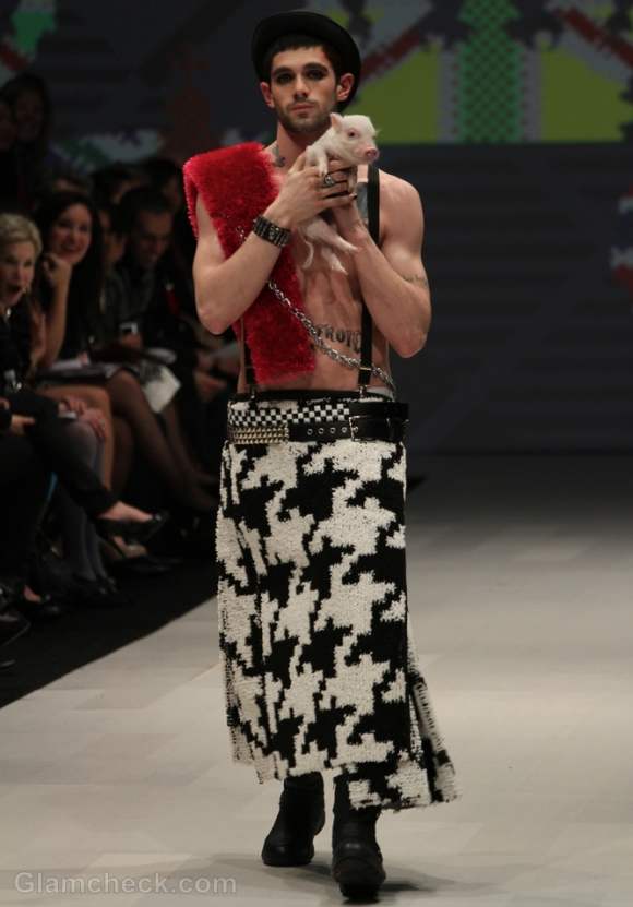 Models walk the ramp with piglets