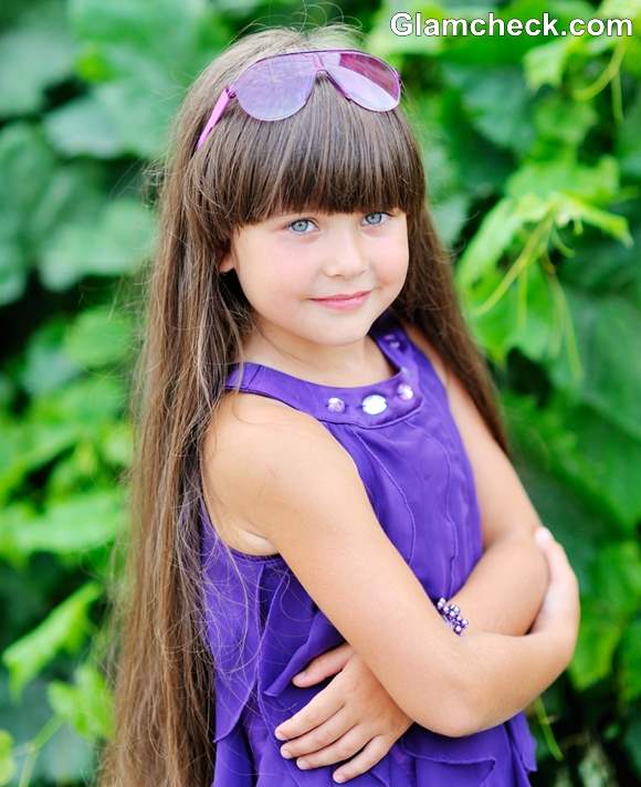 Little girl deals haircuts with bangs