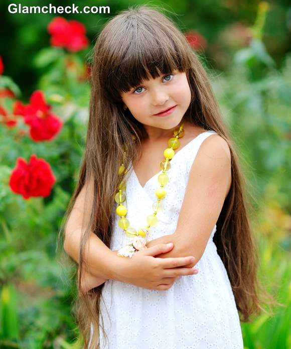 Portrait of smiling little girl brushing her hair closeup  CanStock