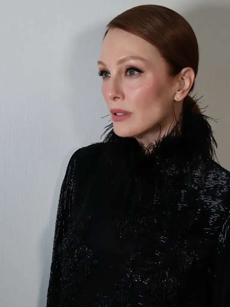 Julianne Moore's auburn hair styled in a smooth low bun with a precise side part