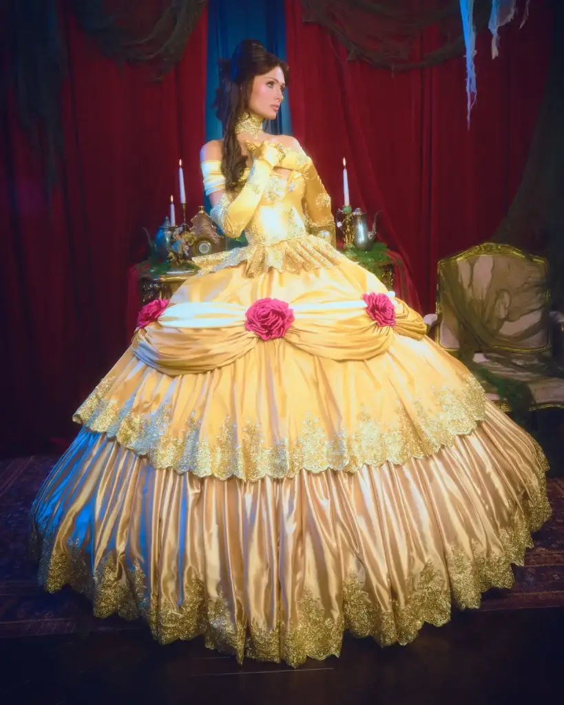 Paris Hilton as Belle in a custom golden-yellow ballgown by Danyul Brown