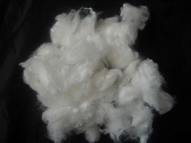 Raw acrylic fiber shown as loose staple before spinning into yarn
