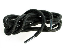 Close view of a shoelace end fitted with a plastic aglet forming a firm pointed tip