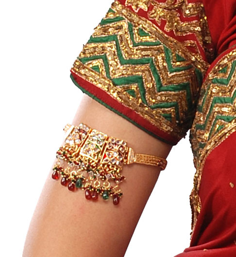 A decorated metal armlet worn high on the upper arm, fitting closely against it
