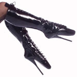 Ballet boots with an extremely high slender heel holding the foot near vertical