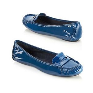 A flat leather loafer with a square toe and slip-on construction