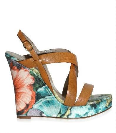 A wedge sandal with a solid raised sole running the full length of the foot